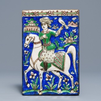 A rectangular moulded tile with a falconer, Qajar, Iran, 19th C.