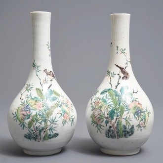 A pair of Chinese famille rose bottle vases with birds and flowers, Yongzheng