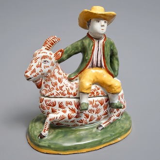 A polychrome Dutch Delft-style butter tub and cover in the shape of a buckrider, prob. Dèsvres, France, ca. 1900