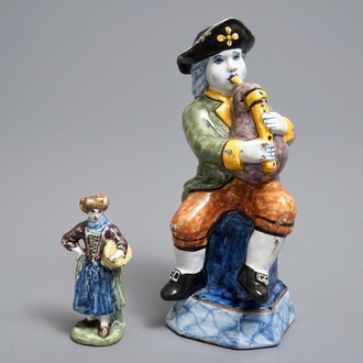 Two polychrome Dutch Delft models of a bagpipe player and a lady, 19th C.