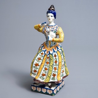 A large polychrome Dutch Delft model of a lady with a dog, 18th C.