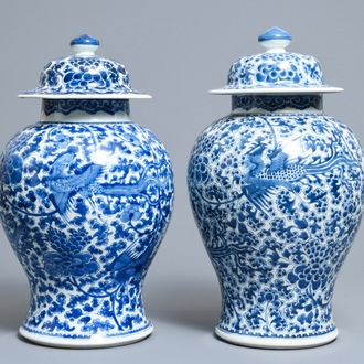 A near pair of Chinese blue and white 'phoenix' vases and covers, Kangxi