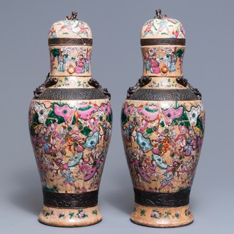 A pair of Chinese Nanking famille rose vases and covers, 19th C.