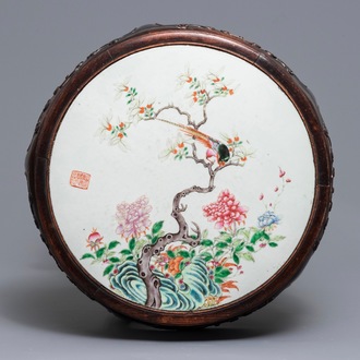 A Chinese famille rose plaque-topped wooden stand, 19/20th C.