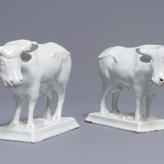 A pair of white Dutch Delft models of cows on bases with frogs, 18th C.