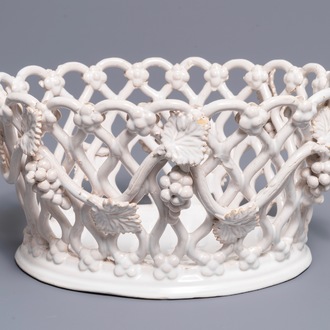 A white-glazed reticulated 'grape vines' basket, France or Italy, 19th C.