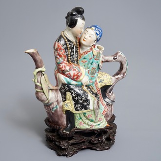 A Chinese famille rose semi-erotic teapot on wooden stand, Republic, 20th C.