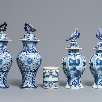 Two pairs of Dutch Delft blue and white covered vases and a drug jar, 18th C.