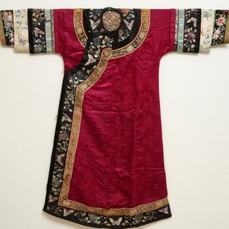A Chinese informal Manchu embroidered silk pink-ground women's robe, 19th C.