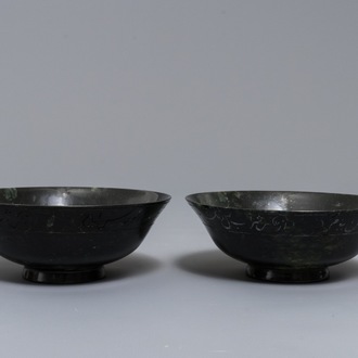 A pair of dark spinach green jade bowls with Arabic or Urdu inscriptions, India, 19/20th C.