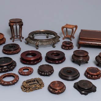 A collection of 22 Chinese wooden stands and one in bronze, 19/20th C.