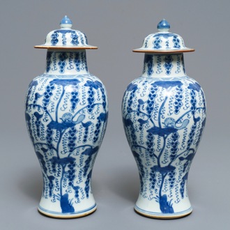 A pair of Chinese blue and white vases and covers with grapes, Kangxi