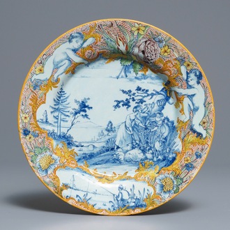 A fine polychrome mixed technique Dutch Delft 'pastoral' plate, 18th C.