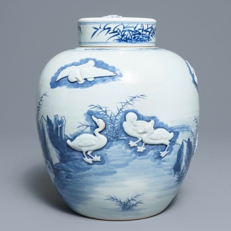 A Chinese blue and white jar and cover with applied design of ducks, Kangxi mark, 19th C.