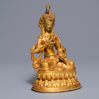 A Tibetan coral- and turquoise-inlaid gilt copper alloy figure of Tara, 19/20th C.