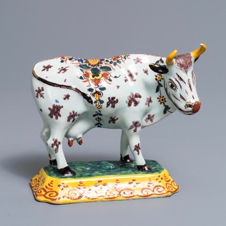 A polychrome Dutch Delft cow on base with frogs, 18th C.