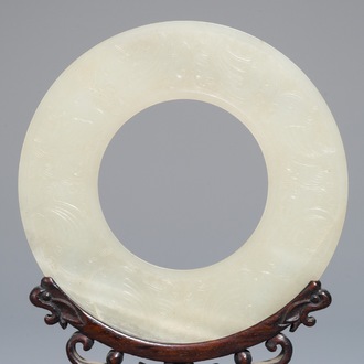 A Chinese pale celadon jade bi disc, Ming or earlier