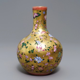 A Chinese famille rose gilt-ground bottle vase with floral design, Qianlong mark, 19/20th C.