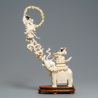 A large Chinese ivory group of an elephant with two ladies, 1st half 20th C.