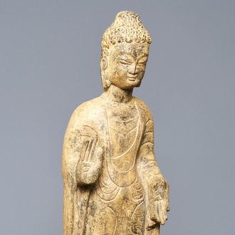 A Chinese carved stone figure of a standing Buddha, Ming or later