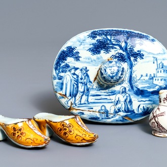 A pair of Dutch Delft polychrome slippers, a miniature jug and a fine lid, 18th C.