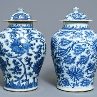 Two Chinese blue and white 'lotus scroll' vases and covers, Kangxi