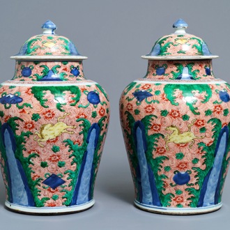 A pair of Chinese wucai 'galloping horses' vases and covers, Transitional period