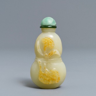 A Chinese pale celadon and russet jade double gourd snuff bottle, 19th C.