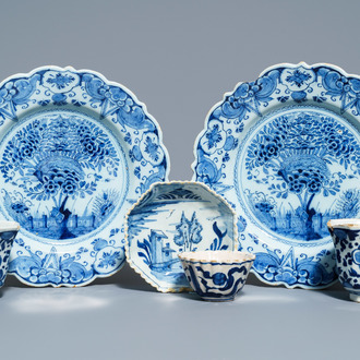 A pair of Dutch Delft blue and white plates, three cups and a saucer, 18th C.