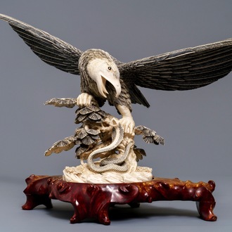 A Chinese carved ivory model of an eagle with a snake, ca. 1930