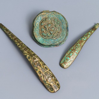 Twee Chinese bronzen gordelhaken met inlegwerk en een ornament, Zhou of Han