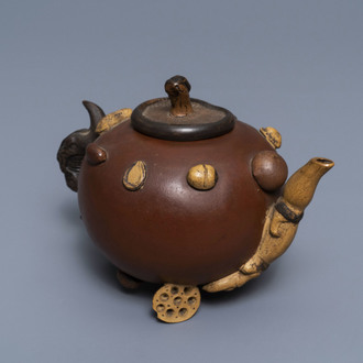 A Chinese Yixing stoneware relief-decorated teapot with nuts and fruits, Shao Er Quan mark, Daoguang