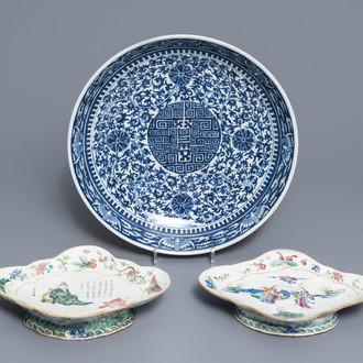 A Chinese blue and white charger and two famille rose bowls, 19th C.