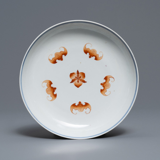 A Chinese iron red and blue and white 'bats and peaches' plate, 19th C.