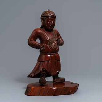 A tall Chinese lacquered wood figure of a guardian, 19th C.