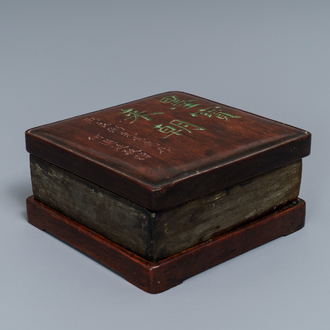 A square Chinese inscribed wood-encased duan inkstone, 19/20th C.