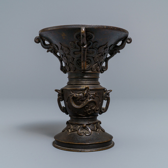 A Chinese relief-decorated bronze 'gu' vase with inscribed base, 18/19th C.