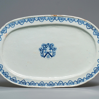 A large blue and white oval French faience dish with the arms of Barres, Rouen, 18th C.