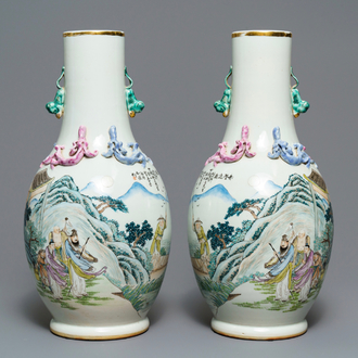 A pair of Chinese famille rose vases with figures in a landscape, 19/20th C.