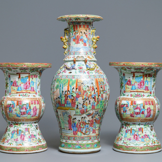 A pair of Chinese Canton famille rose spittoons and a vase, 19th C.