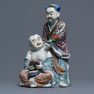 A Chinese famille rose group of two children, impressed marks, Republic, 20th C.