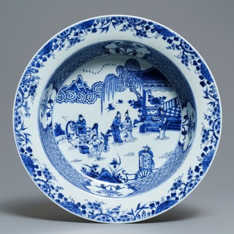 A deep Chinese blue and white dish with figures in a garden, Yongzheng