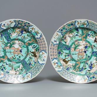 A pair of Chinese famille verte 'mythical beasts' chargers, Kangxi