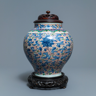 A Chinese wucai 'lotus scroll' jar with wooden cover and stand, Transitional period