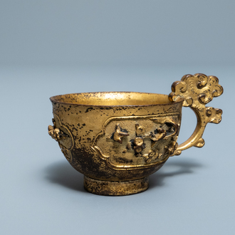 A Chinese relief-decorated gilt bronze cup, Ming