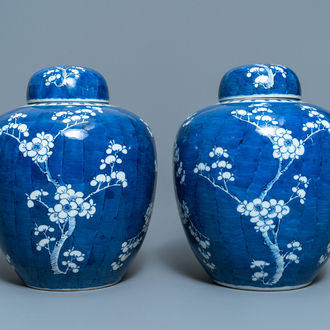 A pair of Chinese blue and white 'prunus on cracked ice' jars and covers, 19th C.