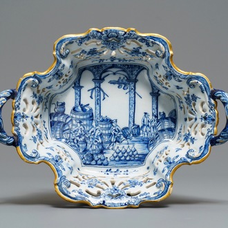 A reticulated Dutch Delft blue and white basket with a view on a wine cellar, 18th C.