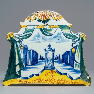 A polychrome Dutch Delft 'landscape' plaque with draperies, 18th C.