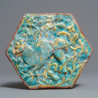 A hexagonal Lajvardina-glazed turquoise-ground tile, Kashan, Iran, 13th C.