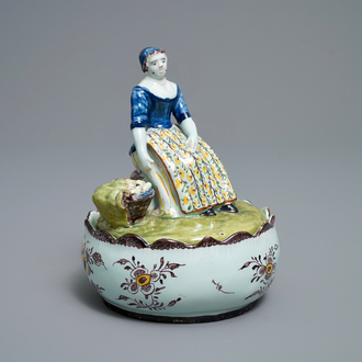A polychrome Dutch Delft butter tub with a lady selling vegetables, 18th C.